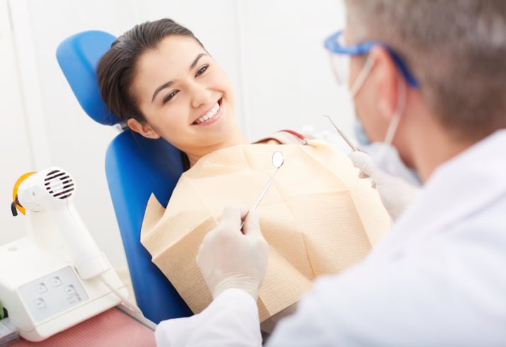 Smiling female patient in dental chair