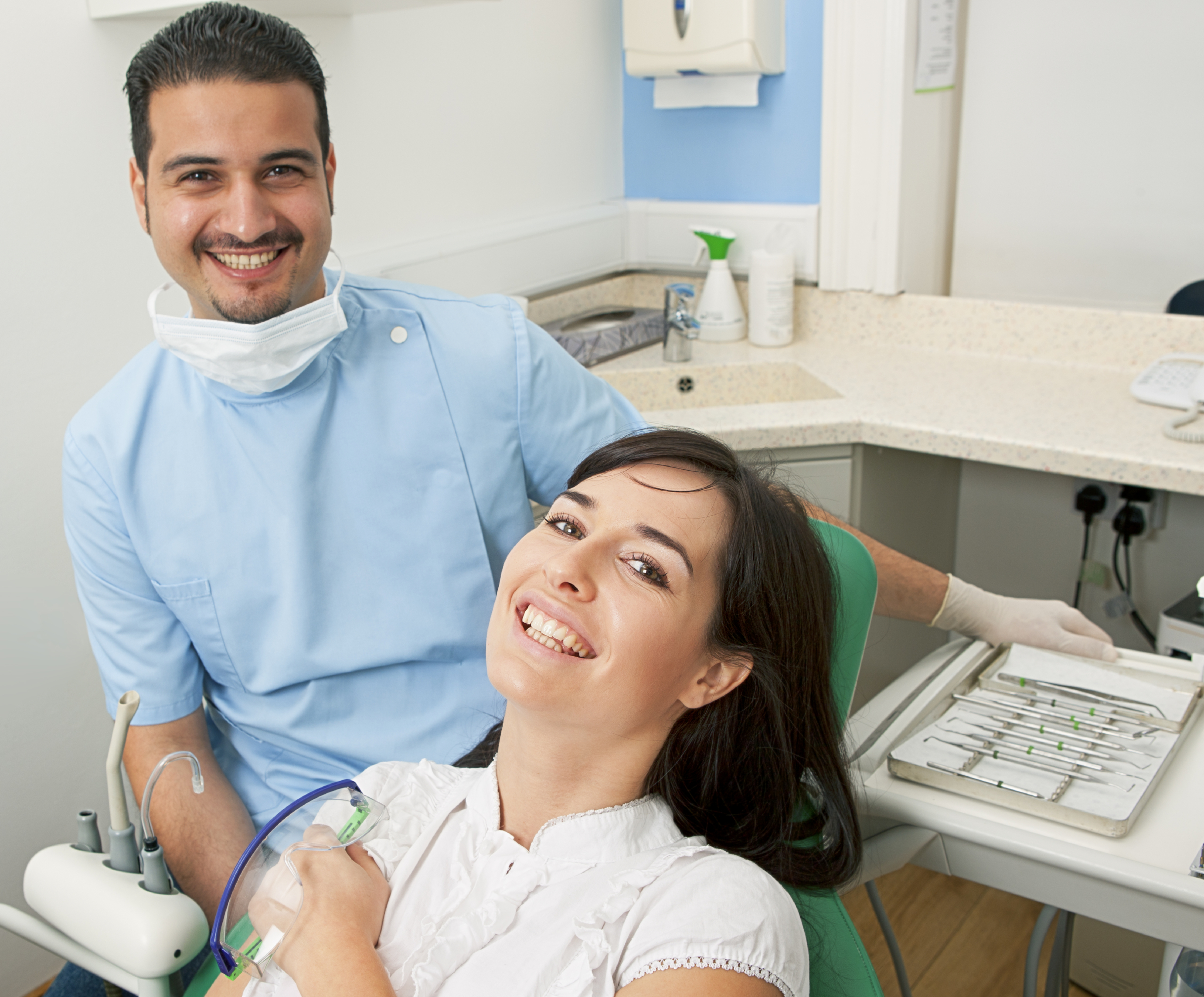 smiling woman and dentist going over dental insurance coverage