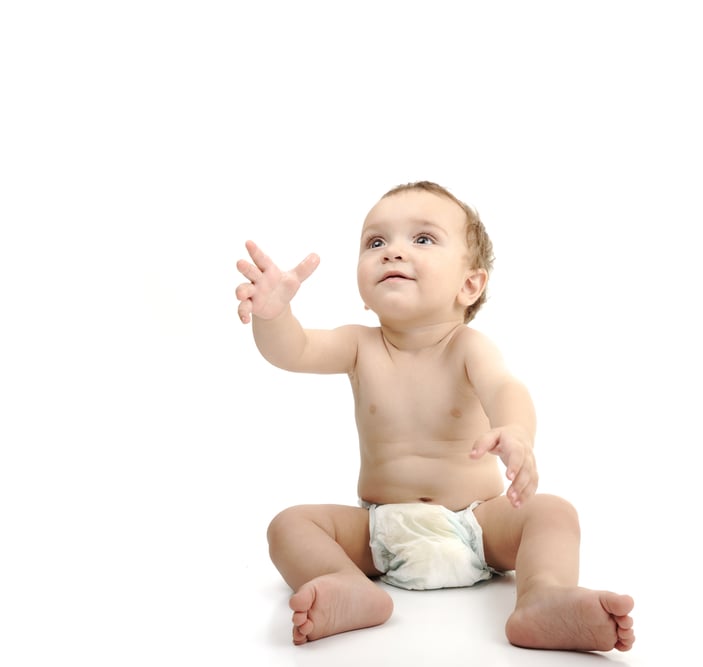 Beautiful cute happy baby isolated on white background. Wearing diaper, large copy-space for your message.