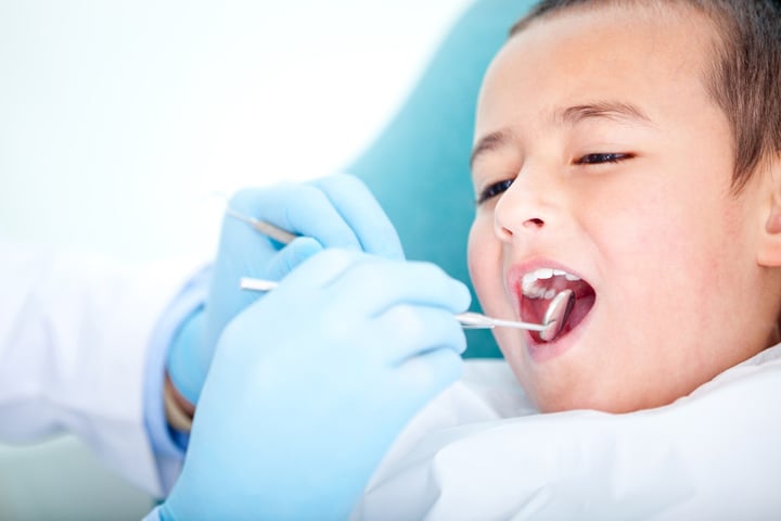 Boy visiting the dentist for cleaning and checkup