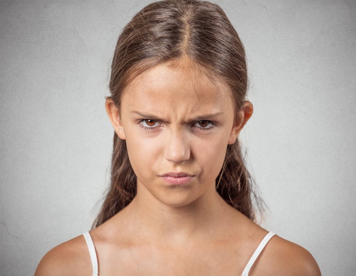 Closeup portrait angry young woman, unhappy teenager about to have nervous, atomic breakdown, isolated grey wall background. Negative human emotions, facial expressions, reaction, feelings, attitude