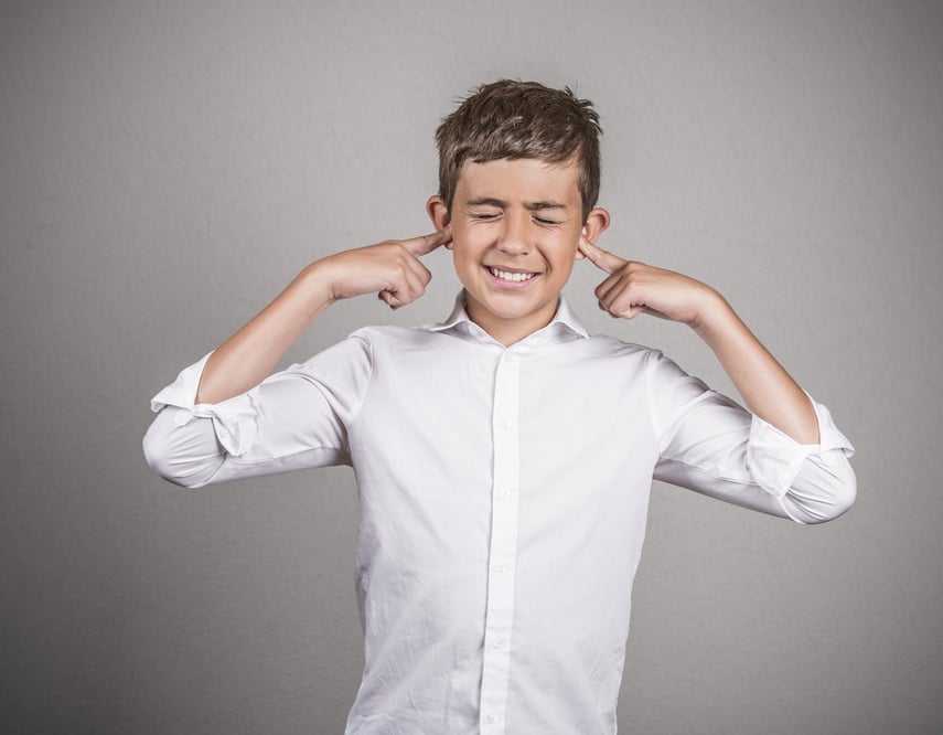 Closeup portrait unhappy, annoyed young man plugging closing ears with fingers disgusted ignoring something not wanting to hear someone side story isolated grey background. Human emotion body language