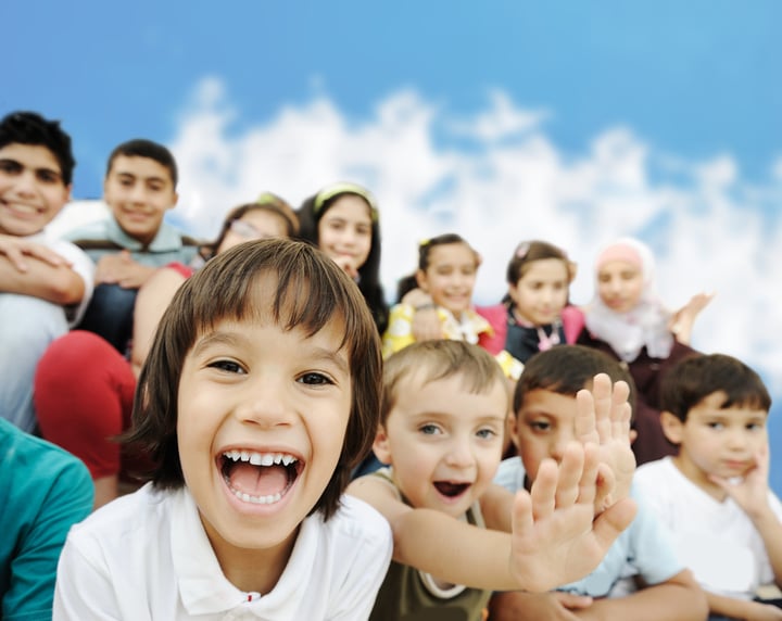 Crowd of children, different ages and races in front of the school, breaktime