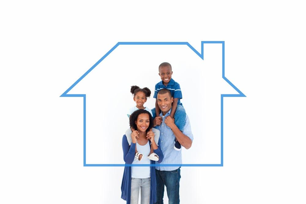 Family giving children piggyback ride against house outline