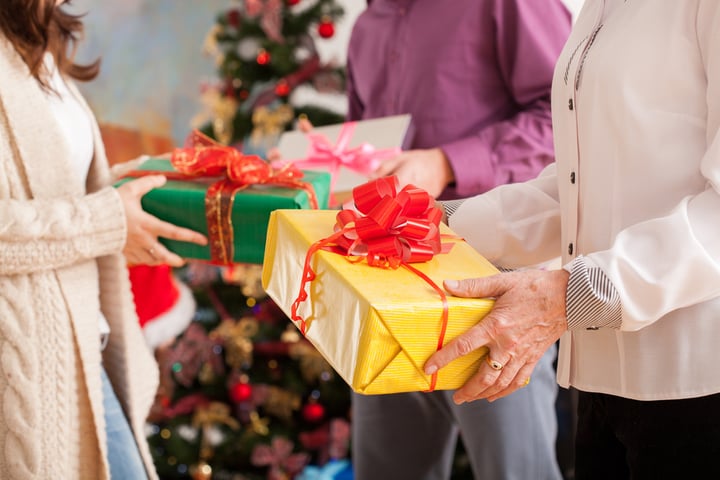 Happy family exchanging theirs Christmas gifts