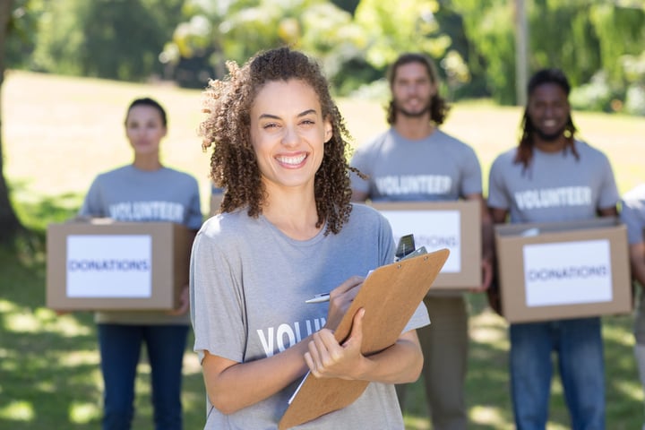 Happy volunteers in the park on a sunny day