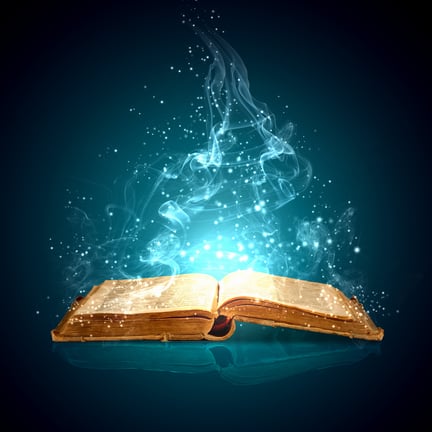 Image of opened magic book with magic lights