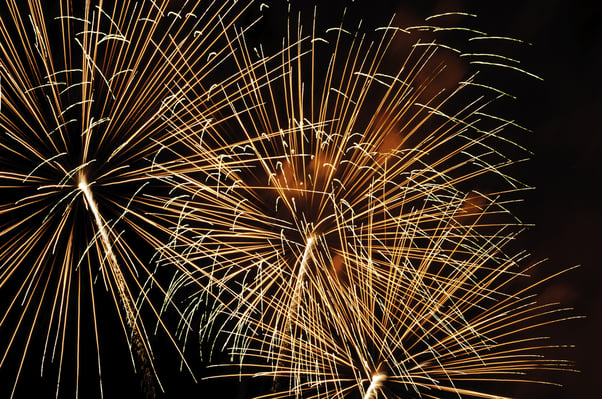 Intermingling of light trails from three bursts of fireworks