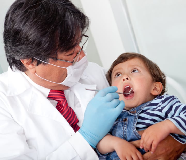 Little boy visiting the dentist and looking scared