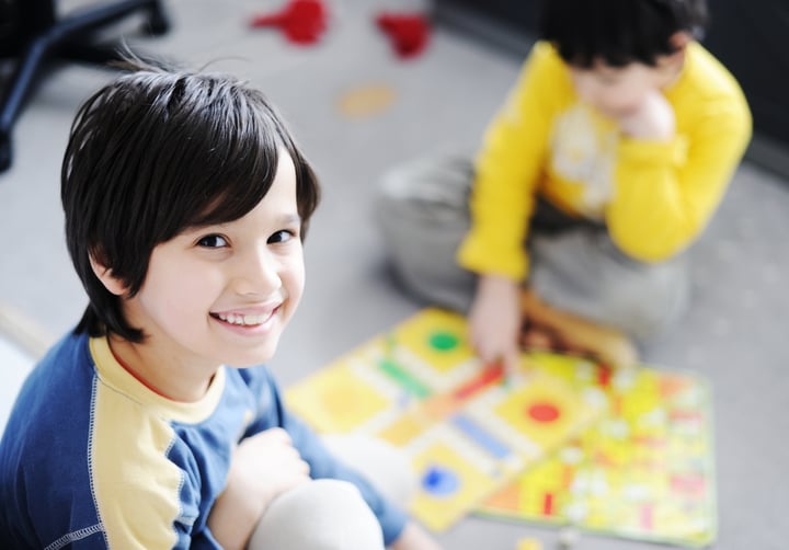 Two kids playing a game of cards
