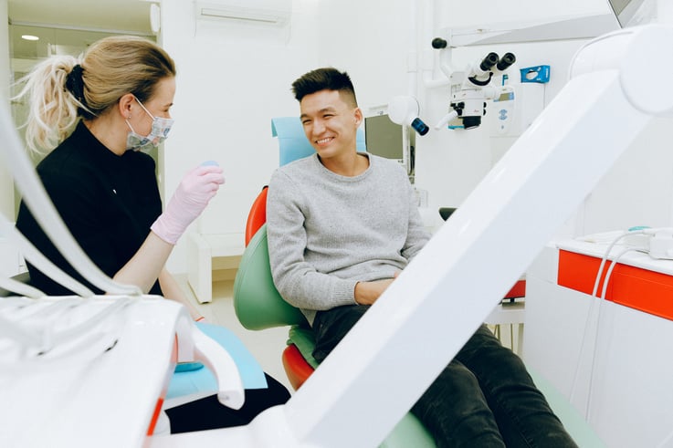 Dentist and smiling patient discussing financial accessibility of care