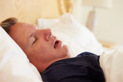 506933401Overweight_Man_Asleep_In_Bed_Snoring.jpg