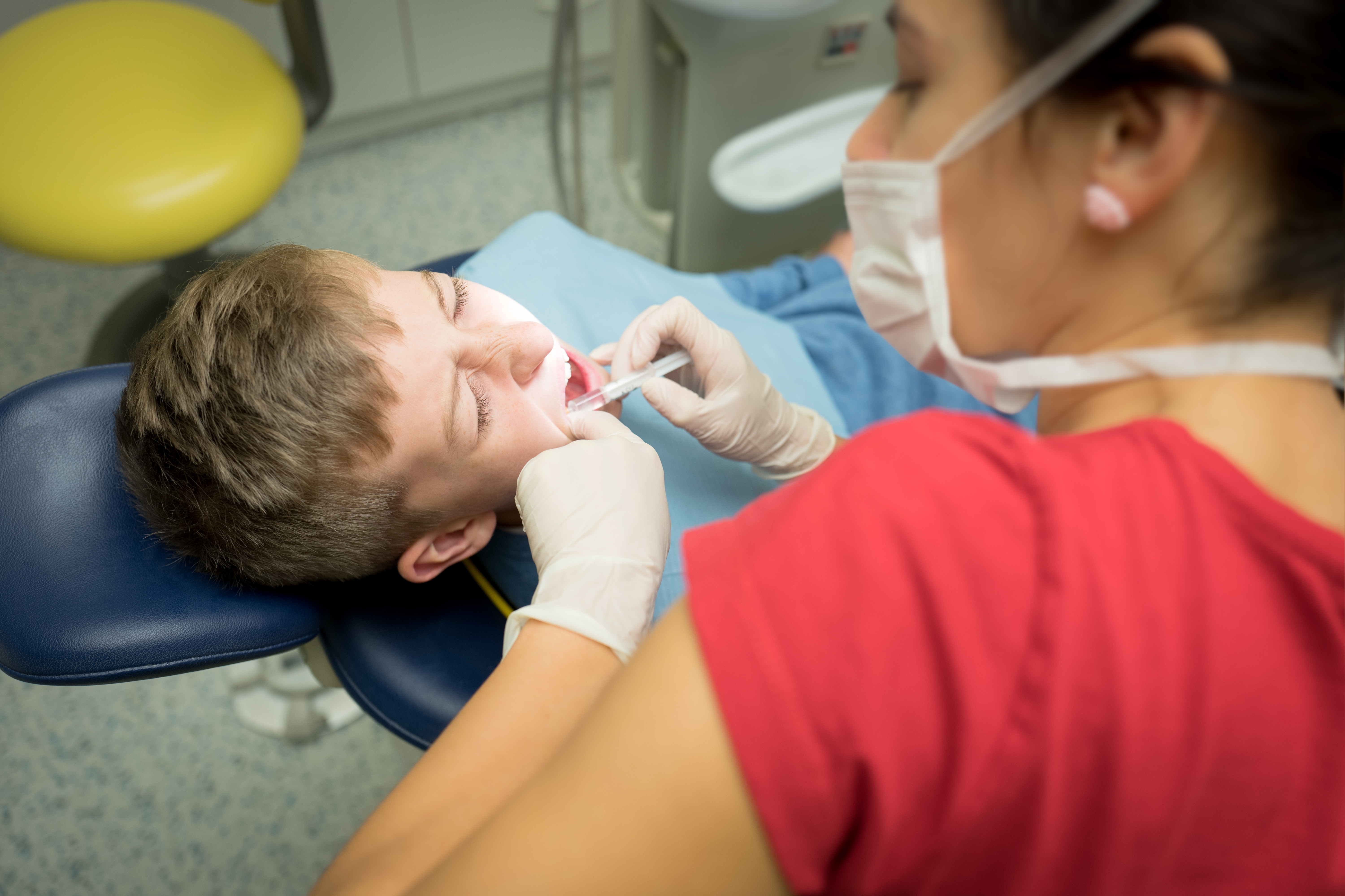 A child getting anesthesia treatment at the dentists office