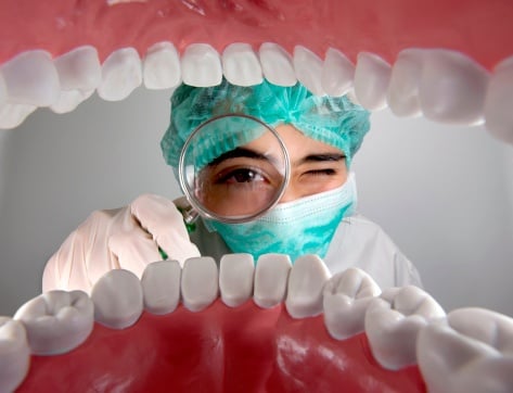 A dentist performing a comprehensive oral evaluation for a patient