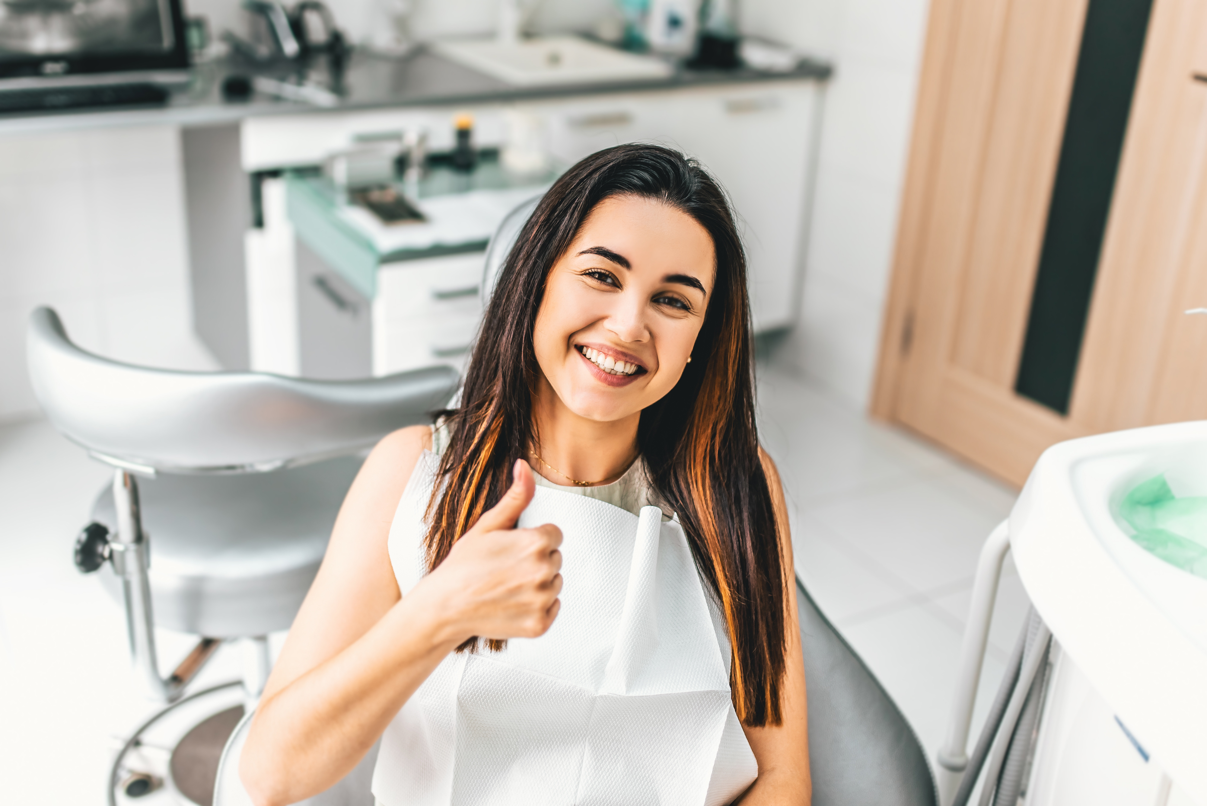 Woman smiling after appointment at her dental practice 