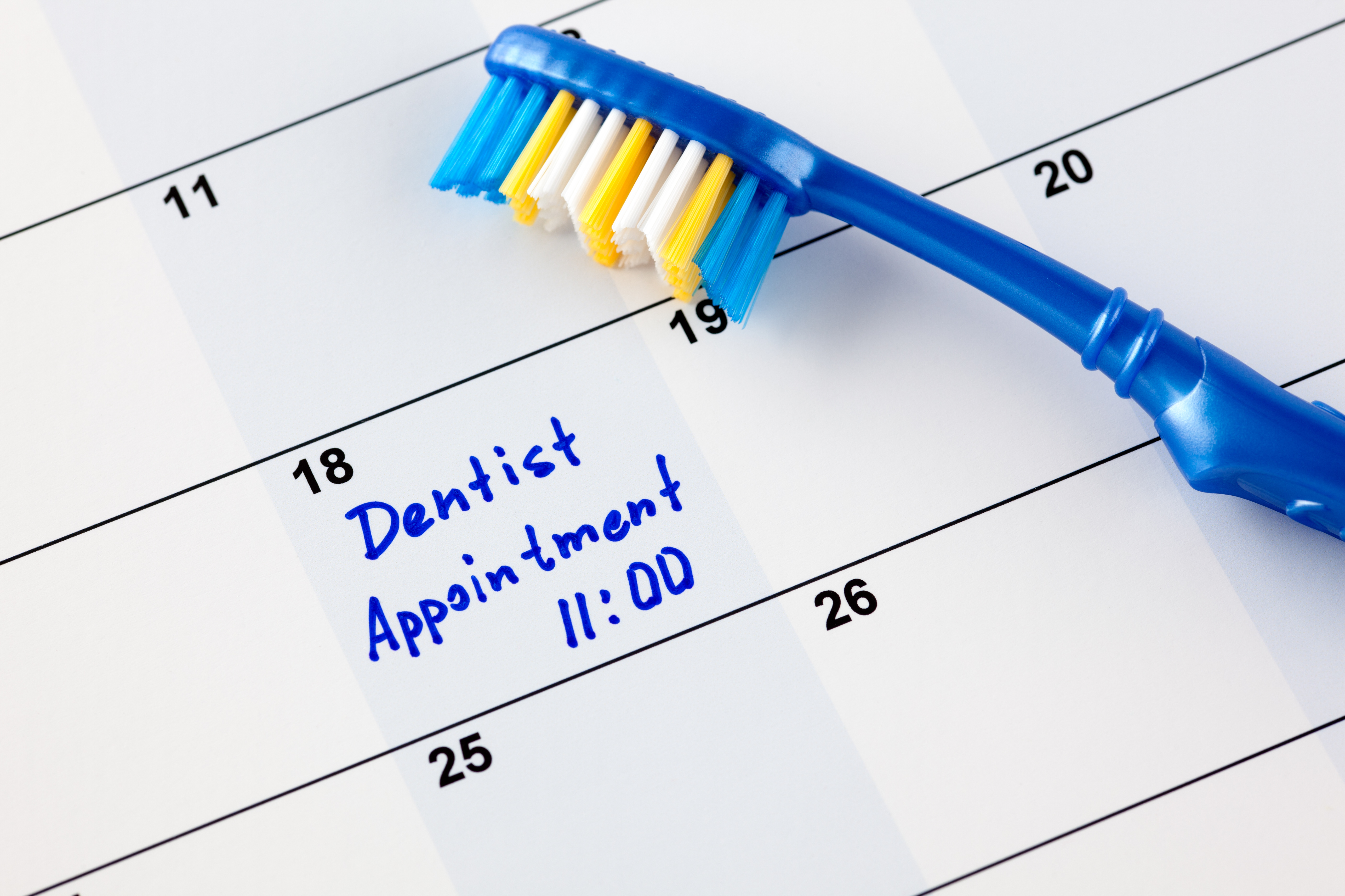 Calendar with a dental appointment reminder and a toothbrush