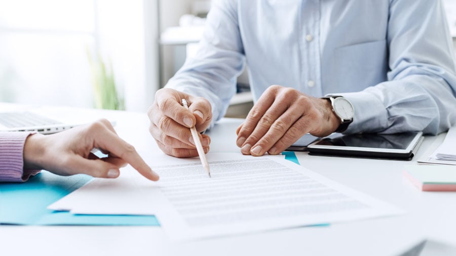 An insurance agent going over a contract with a client