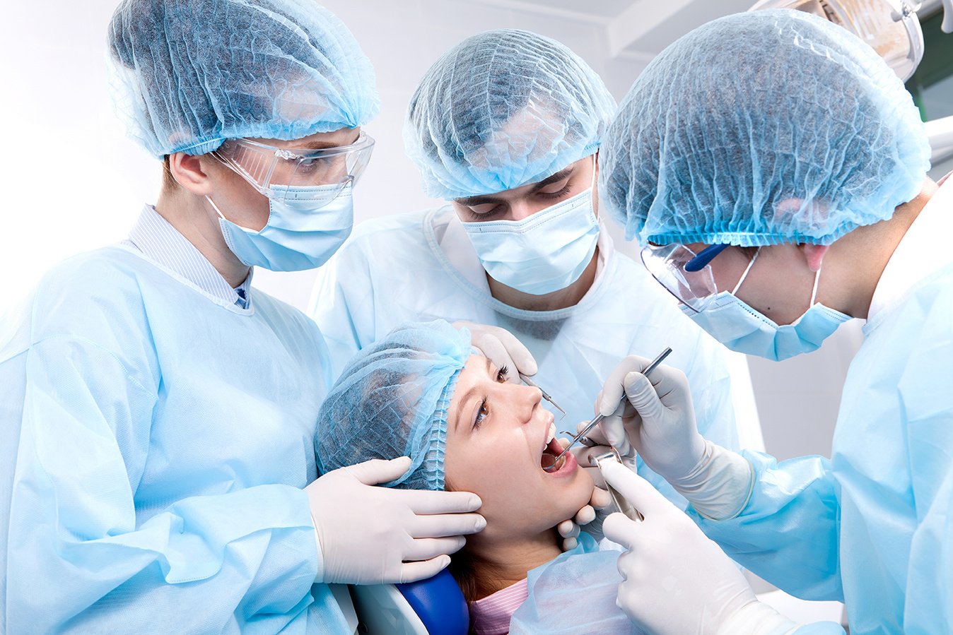 Group of dentists performing an oral surgery