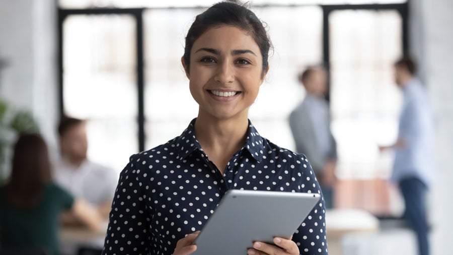 Female insurance agent smiling and holding papers