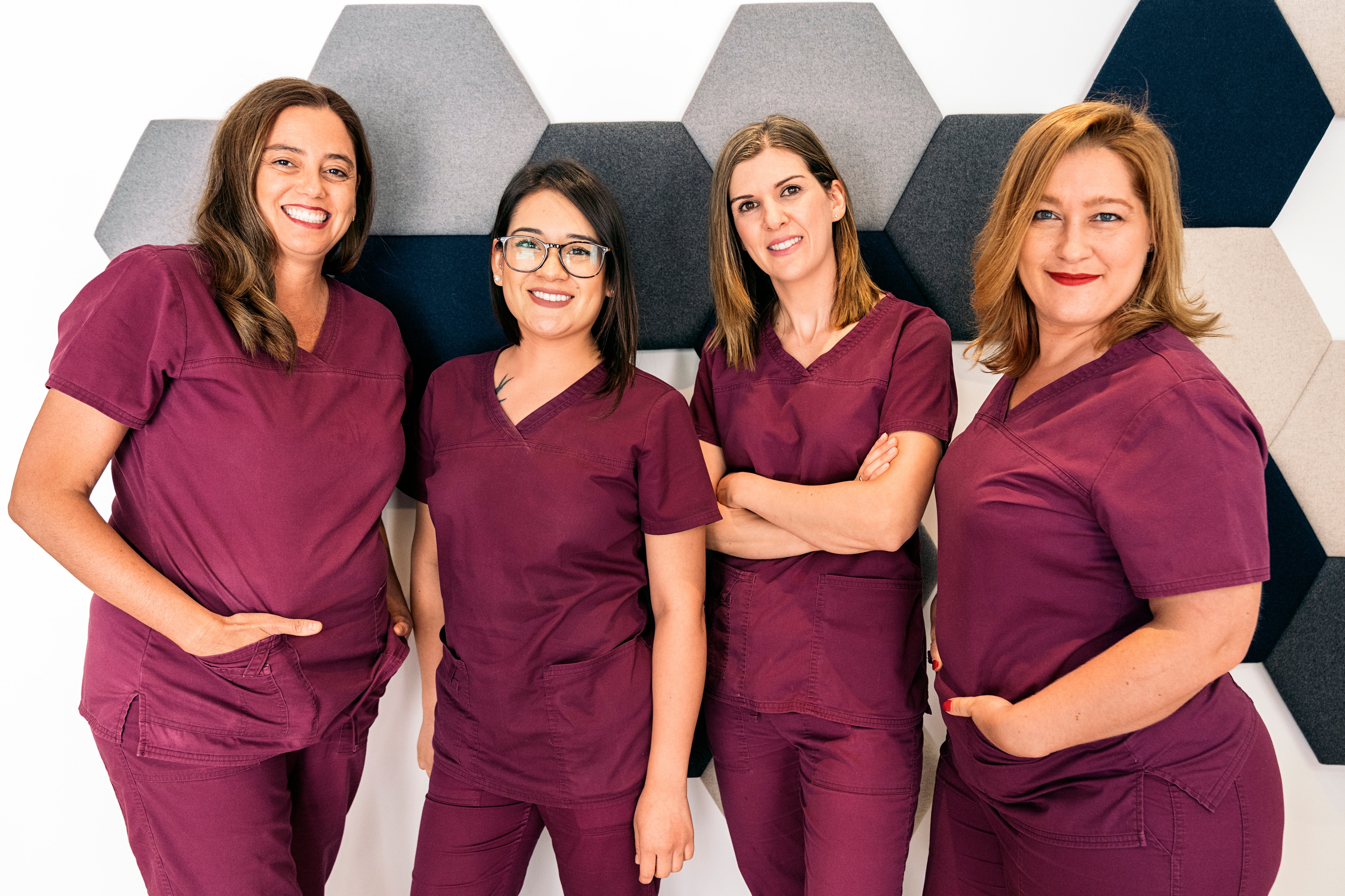 Goup of female dental staff members wearing matching scrubs