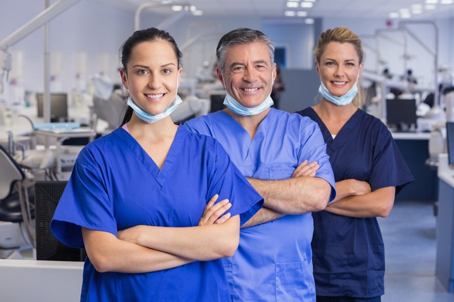 Group of dentists standing and smiling