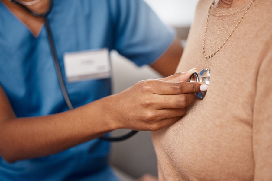 A woman getting her heart checked by a doctor