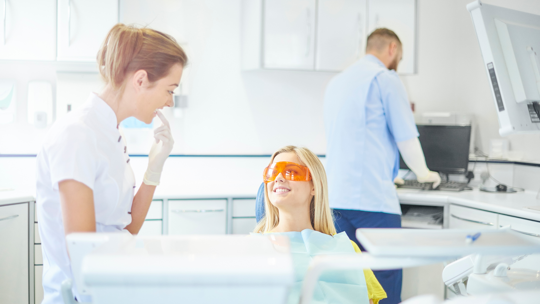 dentist explaining dental cleaning to patient