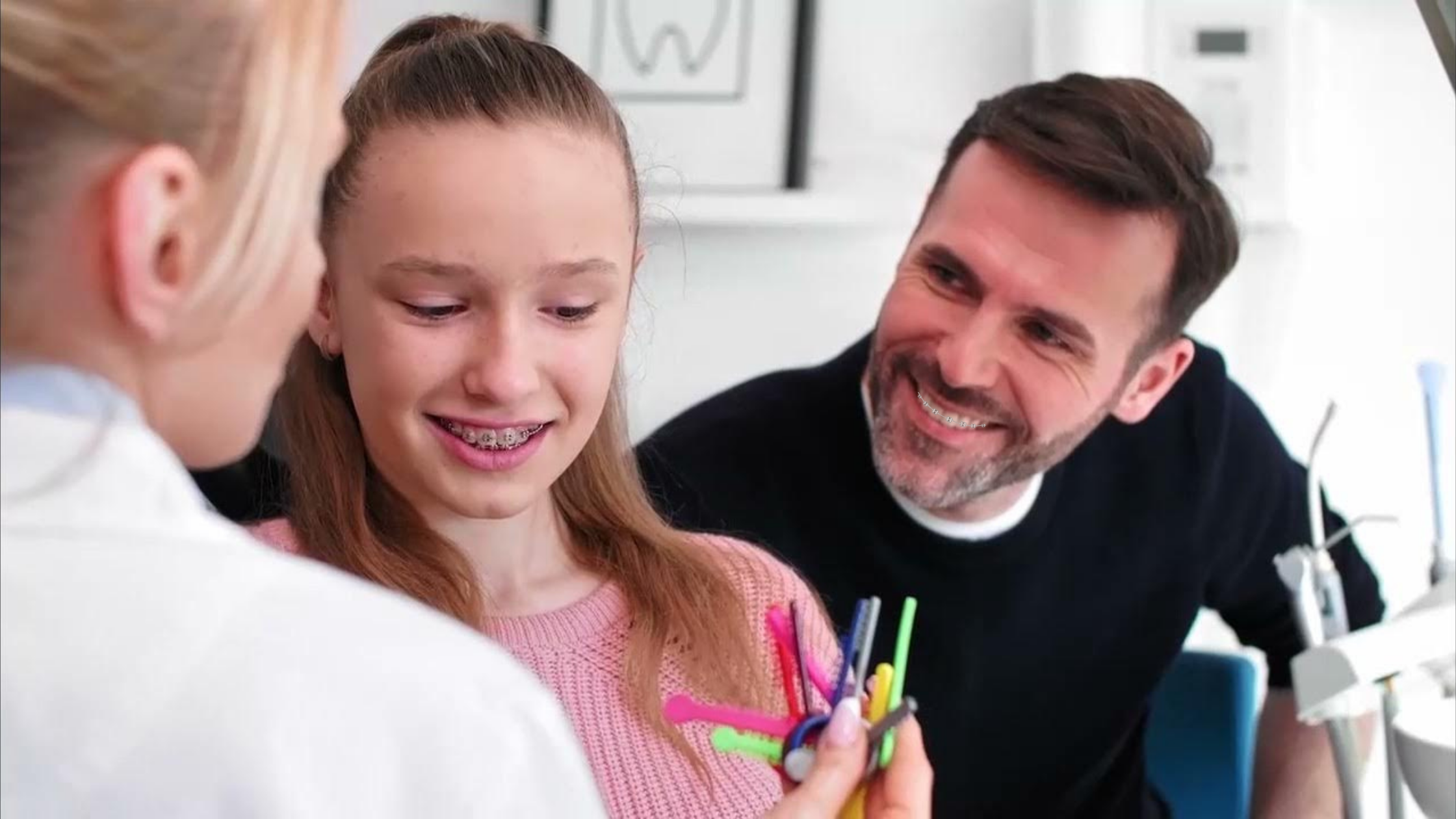 Dad and daughter choosing braces bands colors