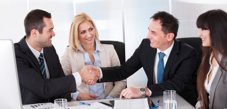 Smiling people in an open enrollment meeting