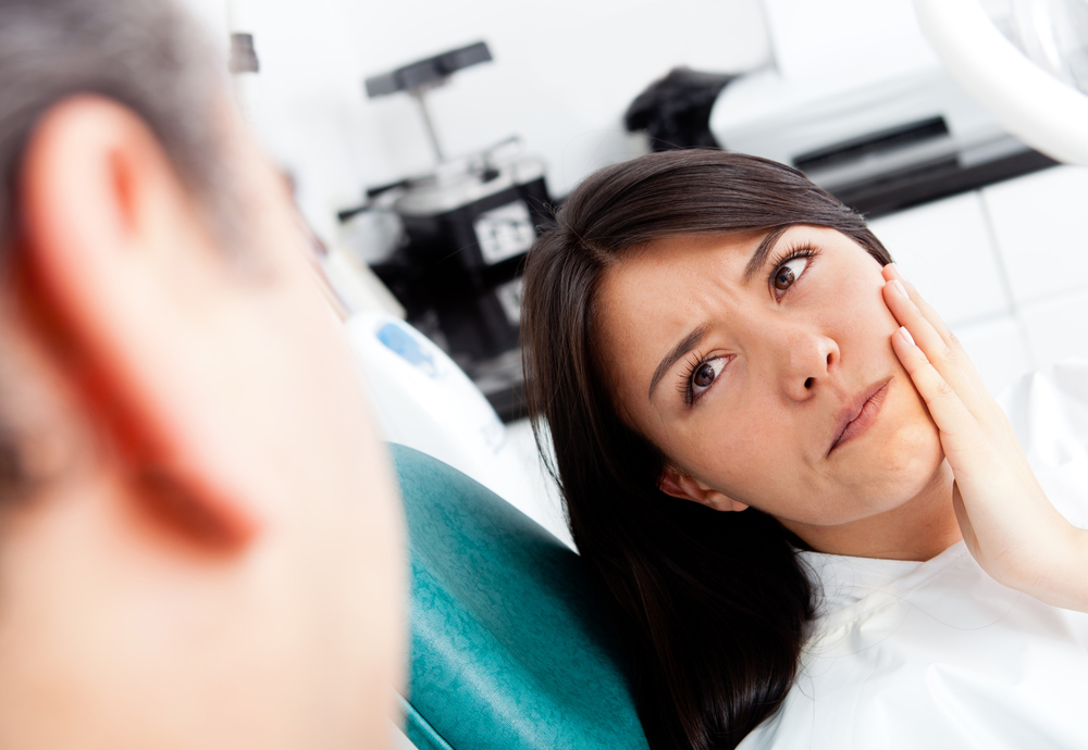 Woman with anxiety being treated by a dentist