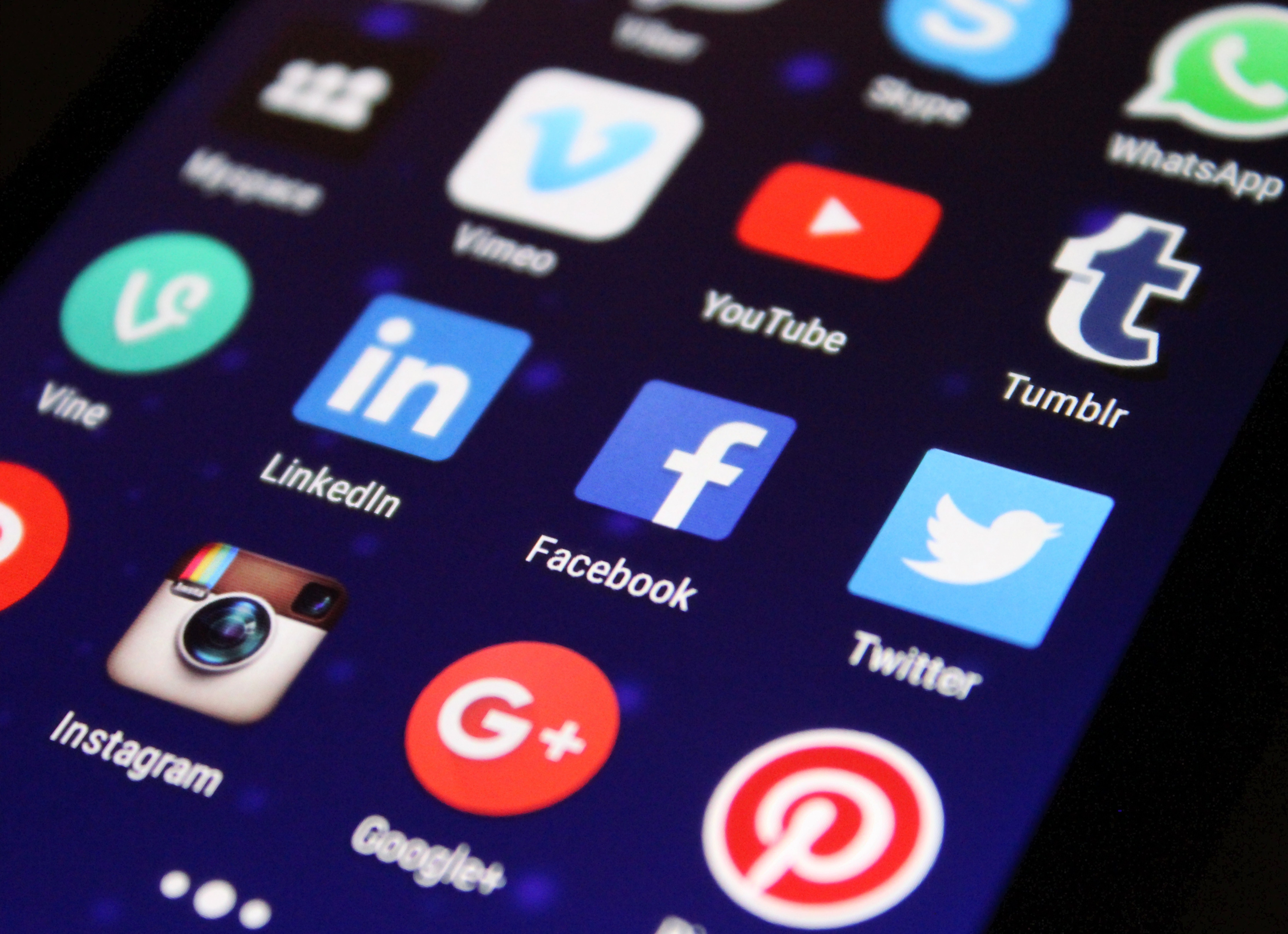 Closeup of smartphone showing social media app icons.