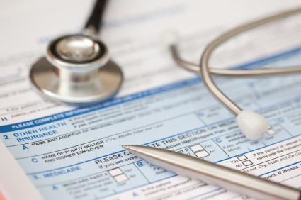 Person filling out insurance paperwork