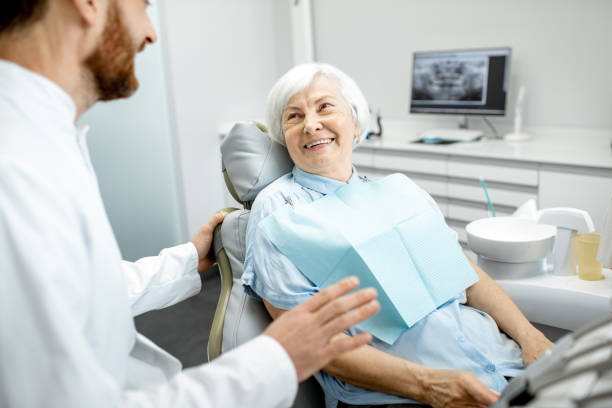 Dentist seeing completing an elderly dental check-up