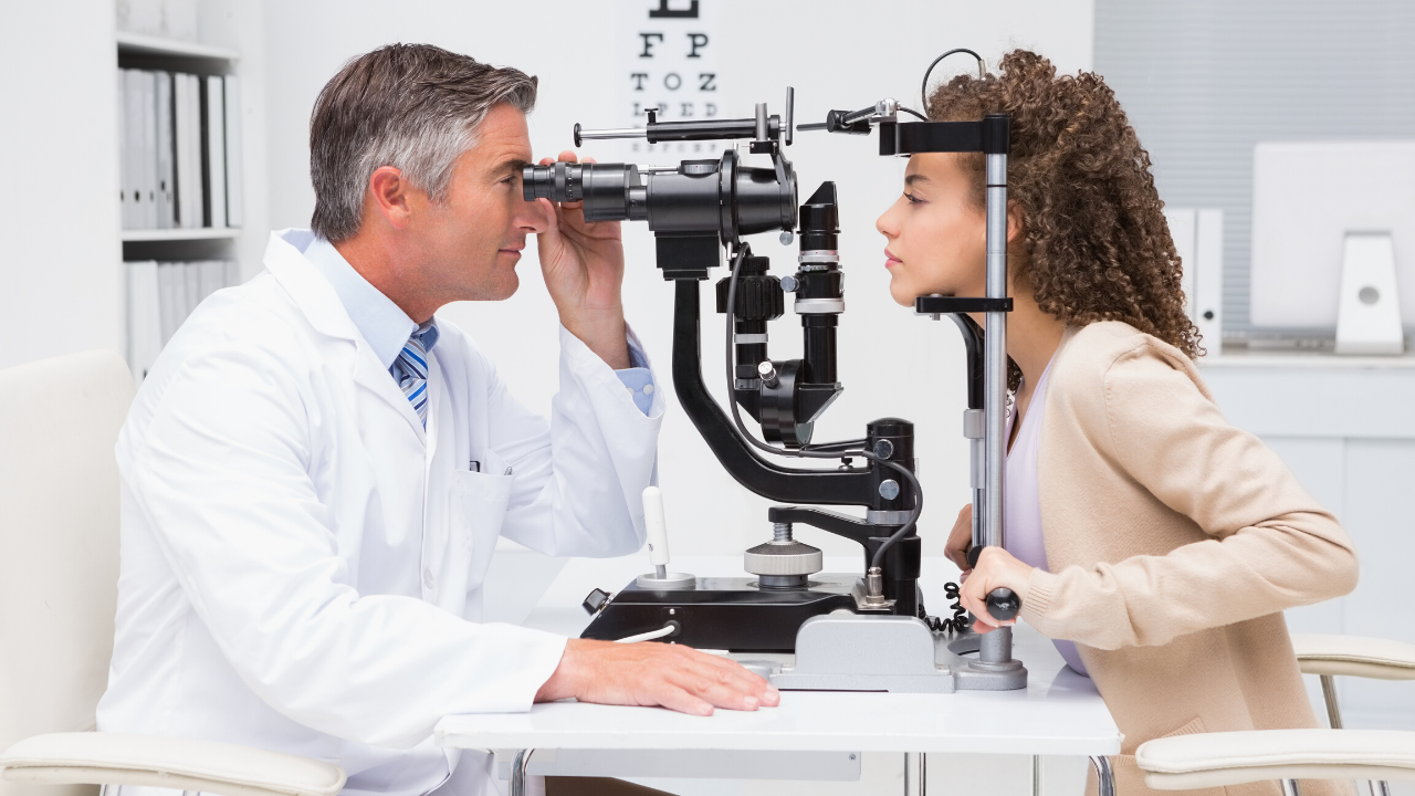 An optometrist giving a patient an eye exam 