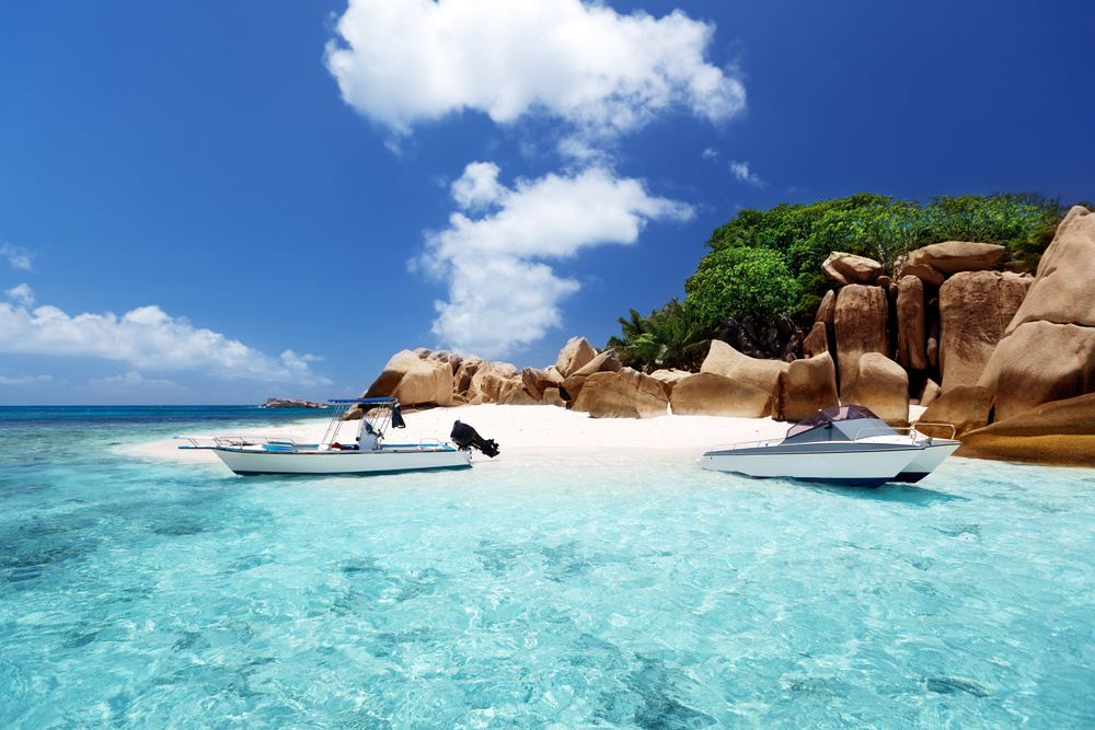Secluded beach with boats on the water