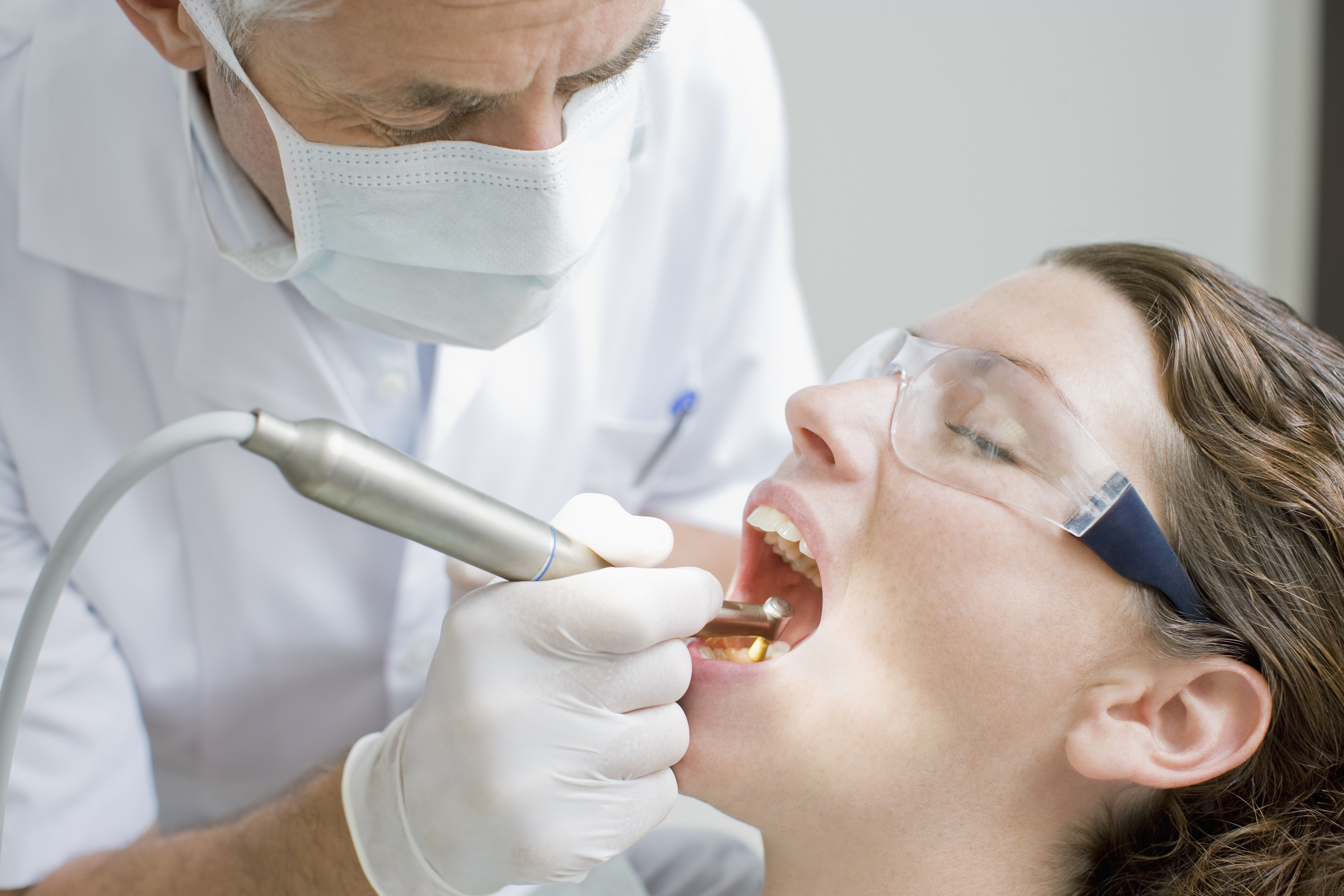 woman getting a procedure done at the dentists office